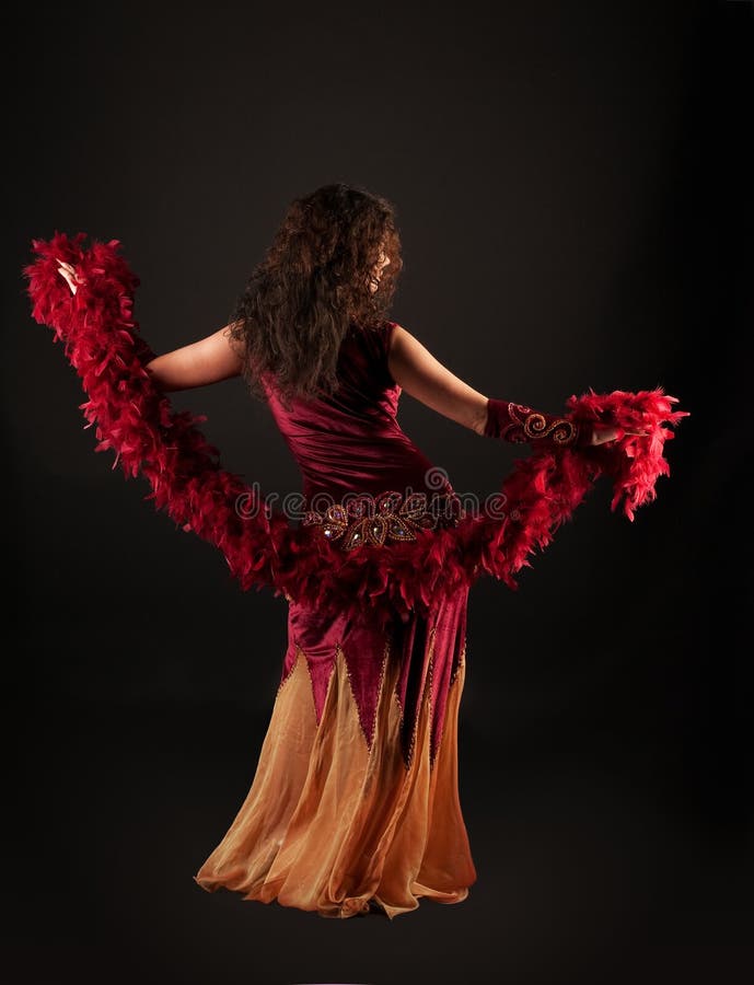 Woman in dark red arabian costume with boa