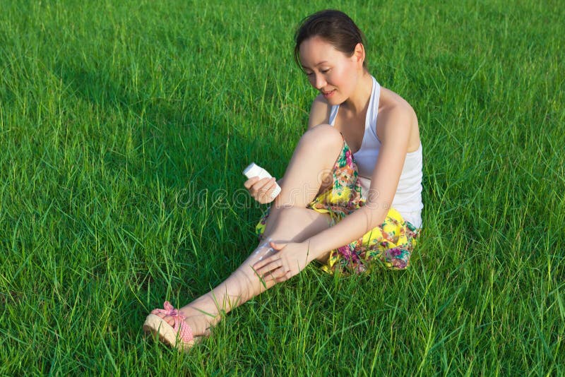 Woman daub cream in field