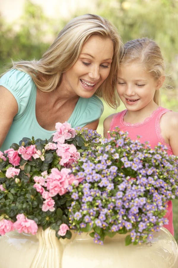 Woman With Daughter Gardening Together