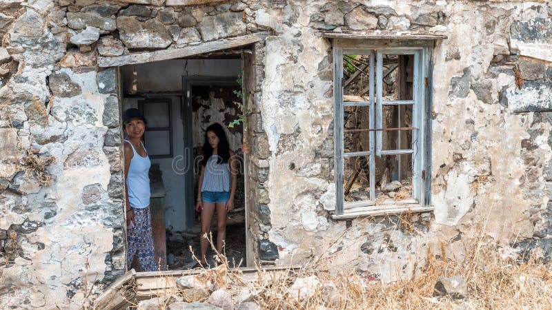 Woman and daughter standing in ruins of abandoned house royalty free stock photography Woman and daughter standing in ruins of abandoned house royalty free stock photography
