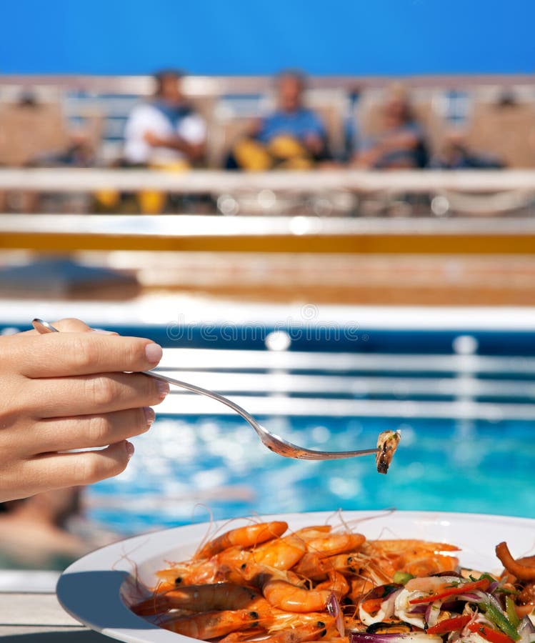 Woman on deck eating seafood cocktail