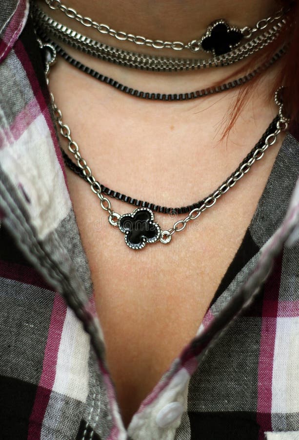 The Woman Decolette in Plaid Shirt with Black and Silver Necklace Stock ...