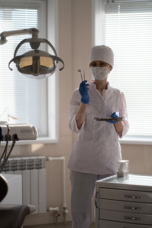 A Woman Dentist in Her Medical Office, Tools in Hand. Stock Image