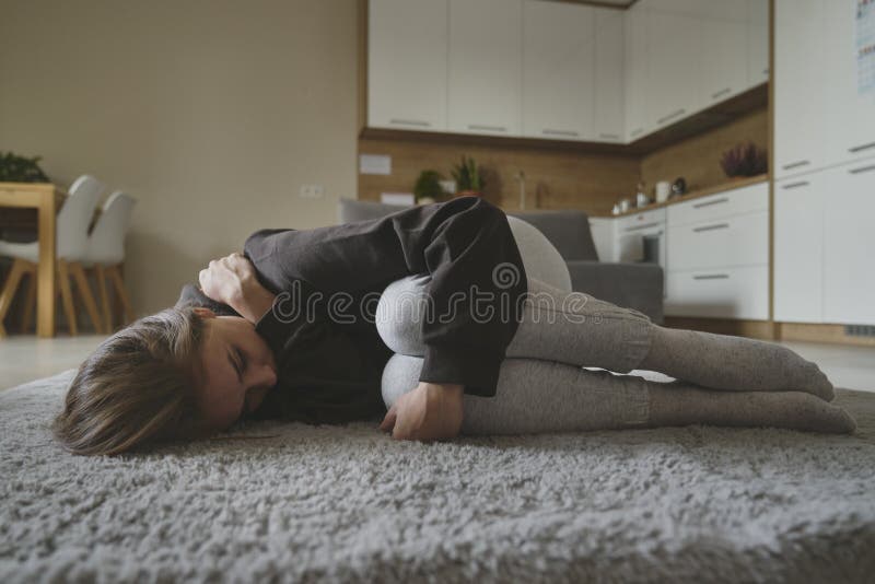 Woman with Depression Lying Down at the Carpet Stock Image Image of