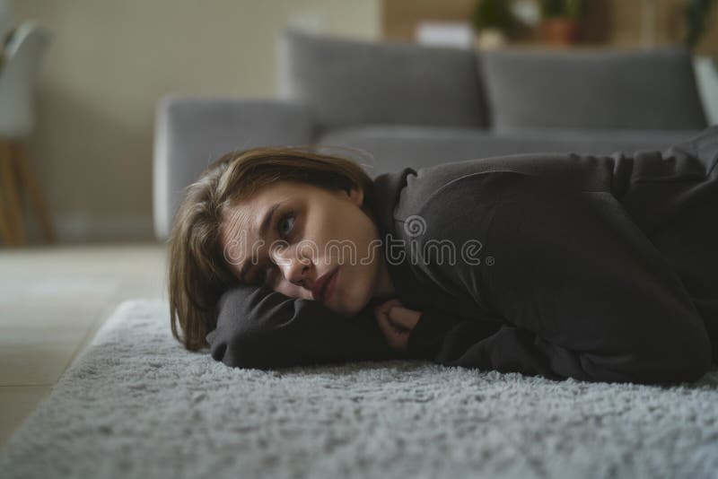 Woman with Depression Lying Down at the Carpet Stock Photo Image of