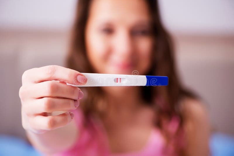 The woman discovering her positive pregnancy test