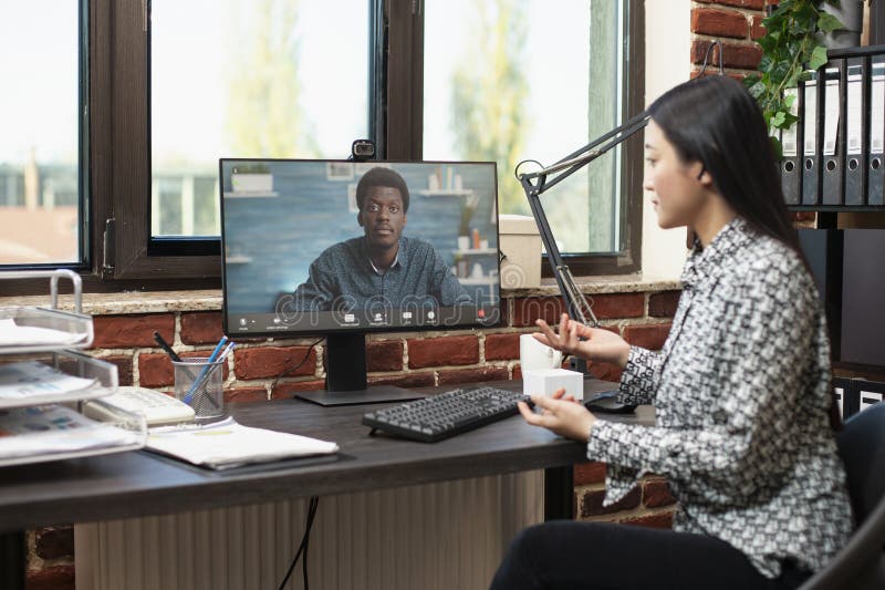 Woman discussing with client online stock photography