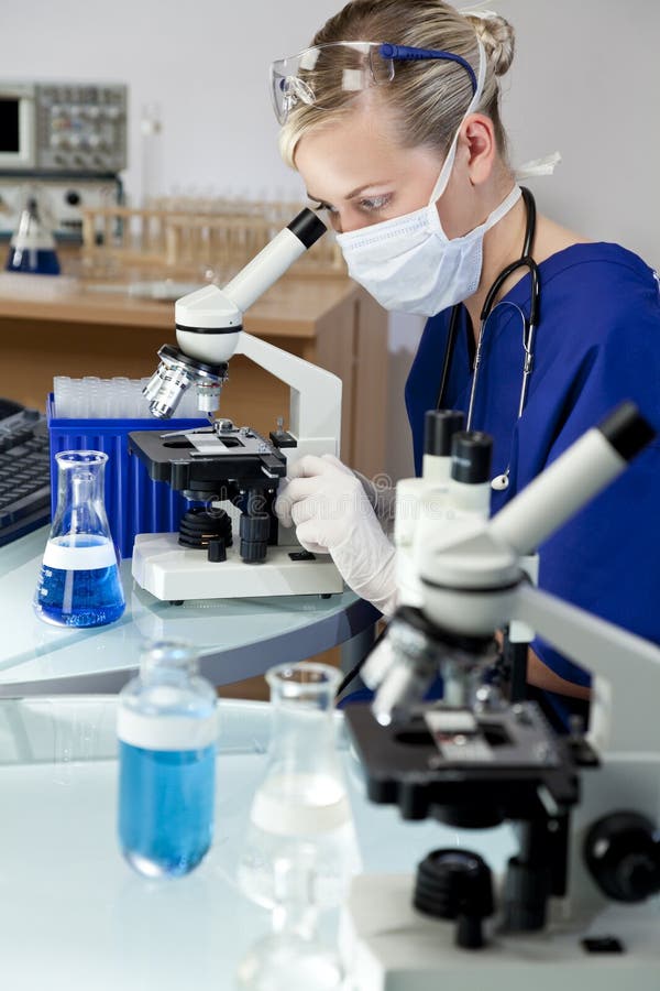 Woman Doctor or Scientist Using a Microscope