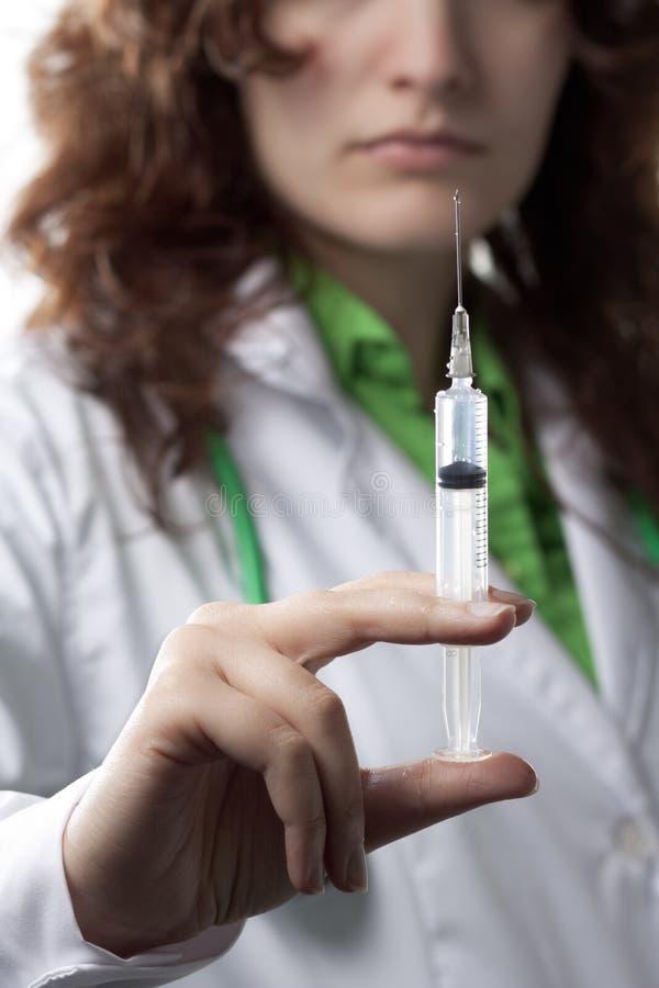 Woman Doctor with Syringe stock photo. Image of confident 18286898