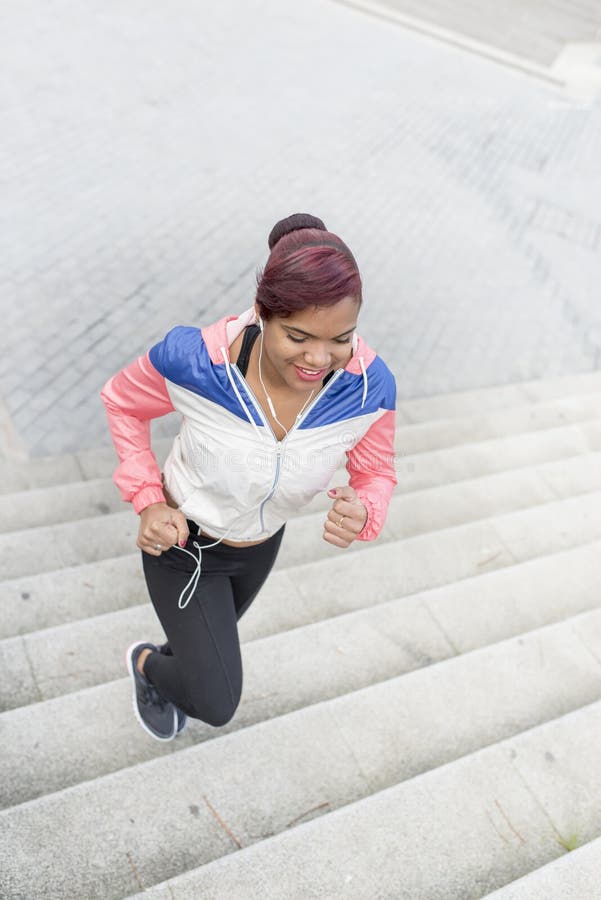 Woman Doing Exercise, Jogging Up and Down the Stairs. Stock Photo