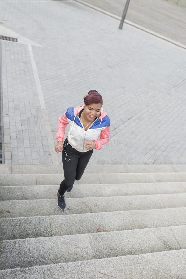 Woman Doing Exercise, Jogging Up and Down the Stairs. Stock Photo