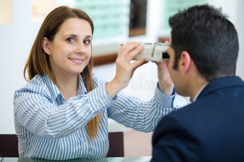 Woman doing eye test with optometrist in eye sight clinic royalty free stock image Woman doing eye test with optometrist in eye sight clinic royalty free stock image