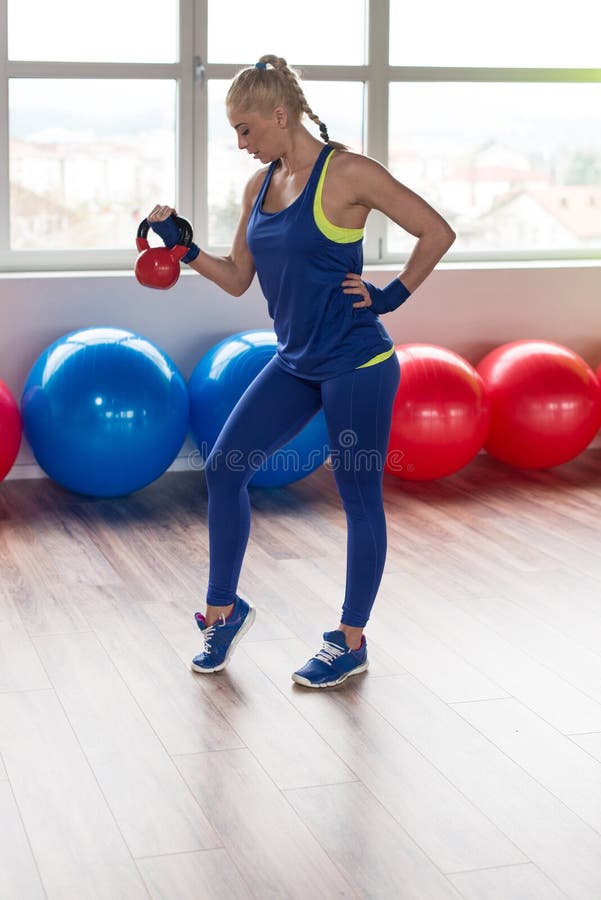 Woman Doing Heavy Weight Exercise With Kettle-bell