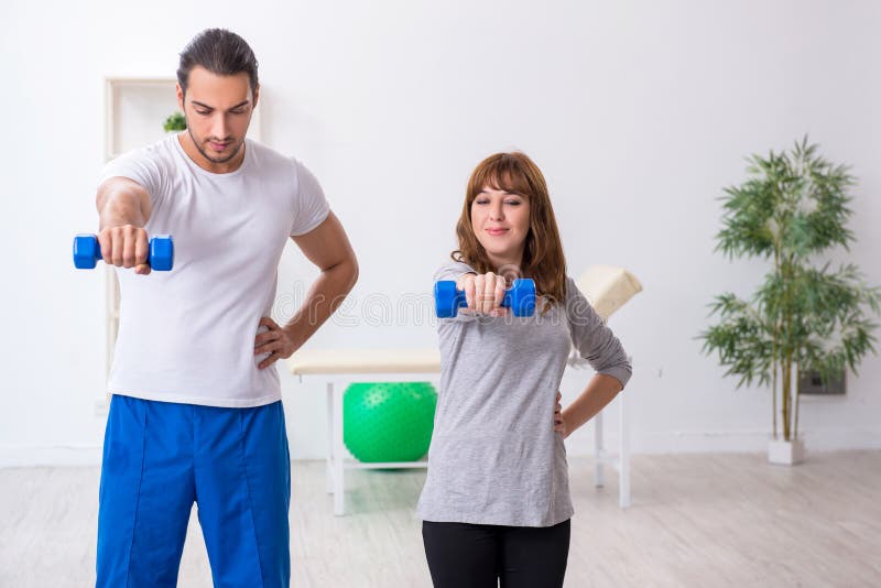Young Woman Doing Sport Exercises with Personal Coach Stock Image