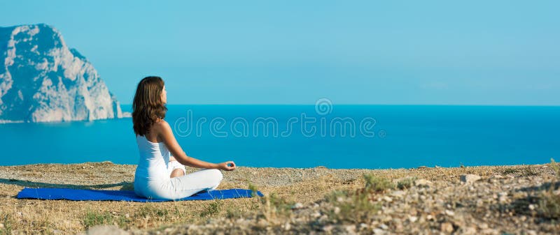 Woman Doing Yoga near the Ocean