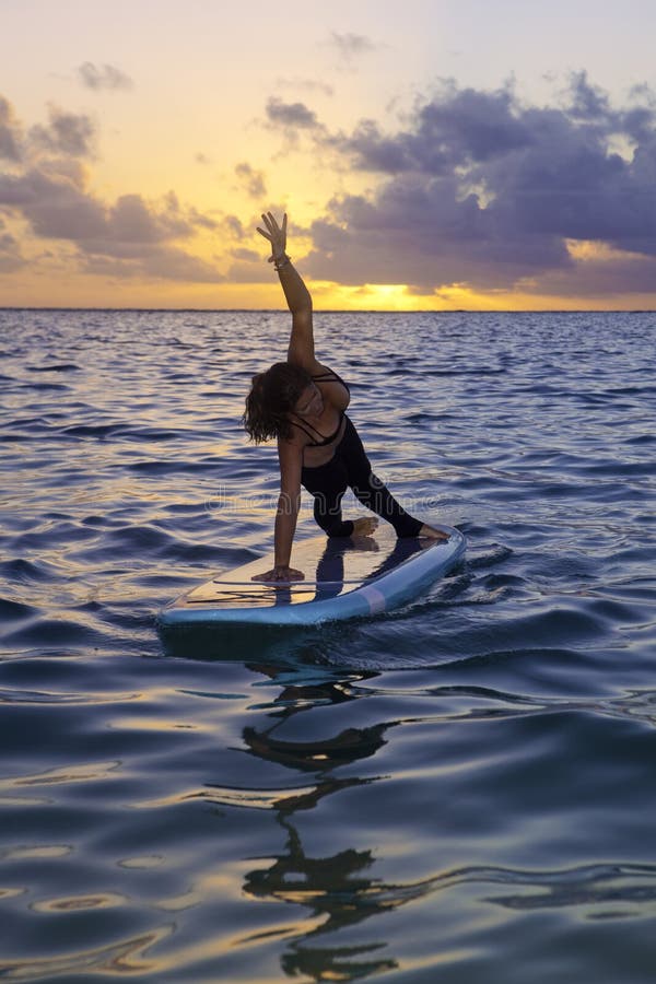 Woman Doing Yoga on a Paddle Board Stock Photo - Image of ocean, hawaii ...