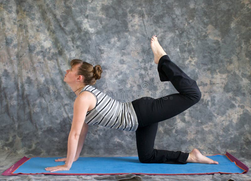 Woman doing Yoga posture Tiger Pose