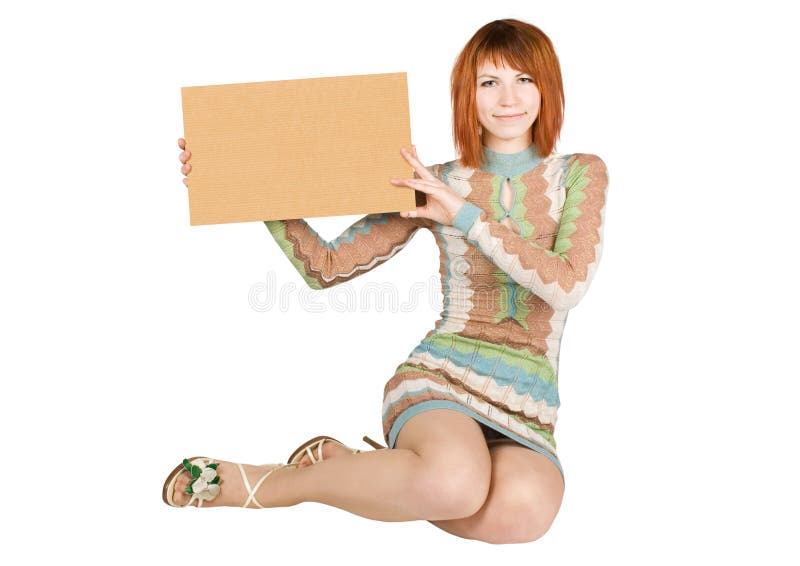 Woman in dress sitting and holding cardboard