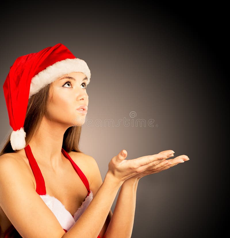 woman dressed as Santa blowing