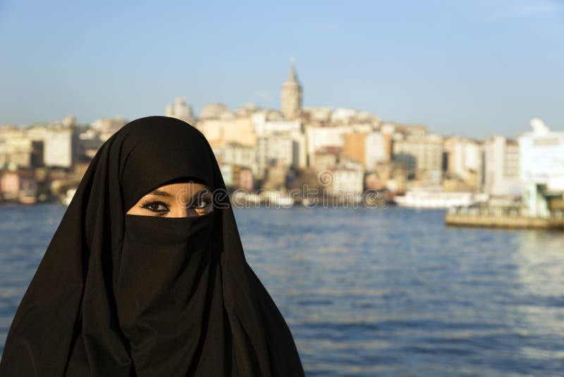 Woman Dressed Black Headscarf, Chador Eating Simit 
