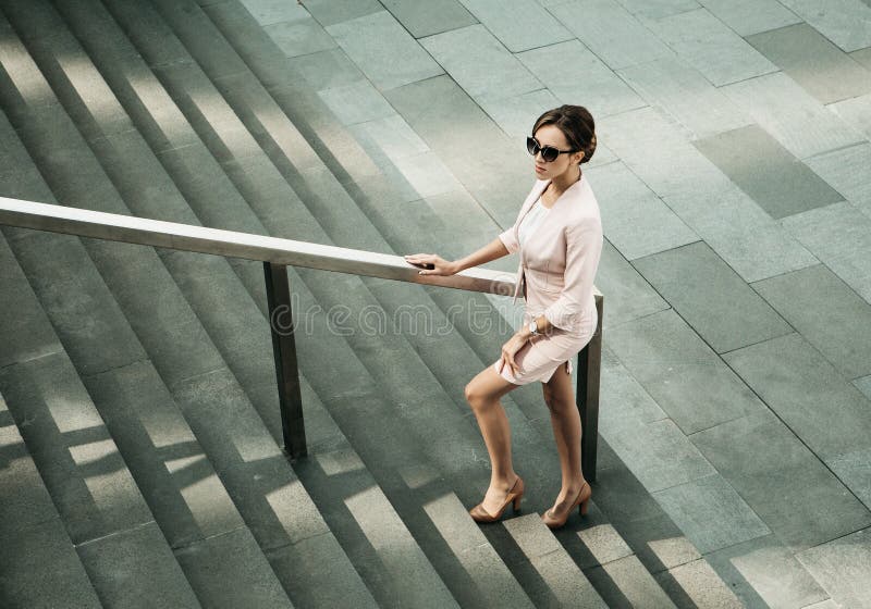 Woman dressed in business style next to the stairs, business and career concept