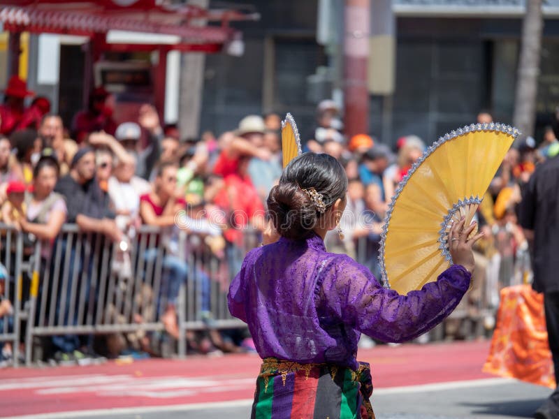 Woman dressed in traditional Mexican wear waves fans in front of royalty free stock photography Woman dressed in traditional Mexican wear waves fans in front of royalty free stock photography
