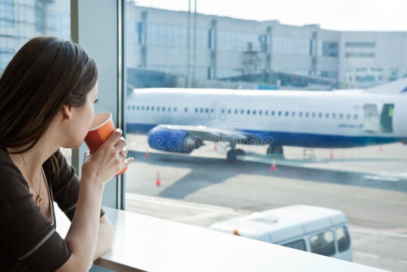 Woman drink coffee in airport