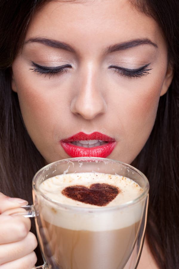 Woman drinking cappuccino coffee with love heart s stock image Woman drinking cappuccino coffee with love heart s stock image