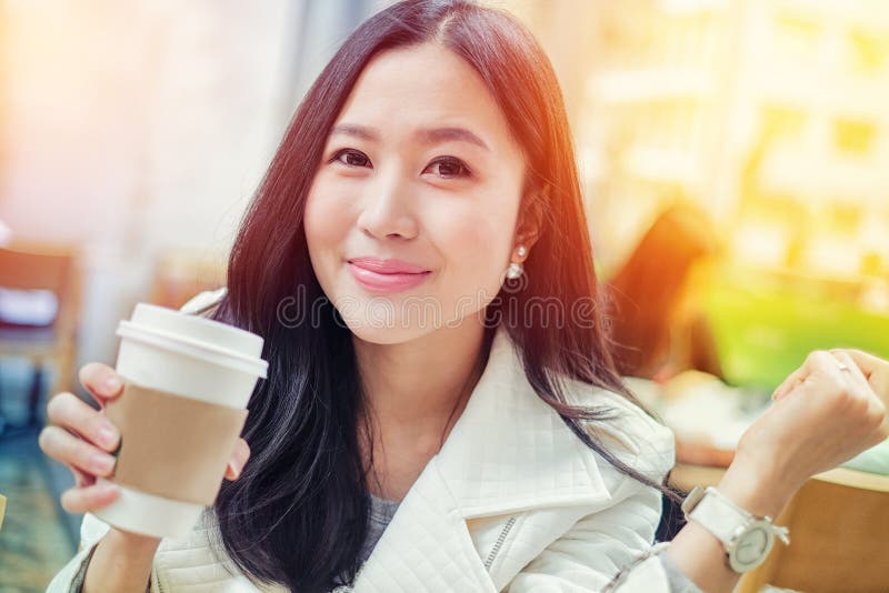 Woman drinking coffee at coffee shop