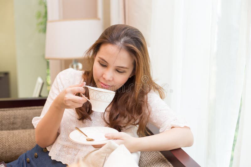 https://thumbs.dreamstime.com/b/woman-drinking-coffee-sofa-her-living-room-34588498.jpg