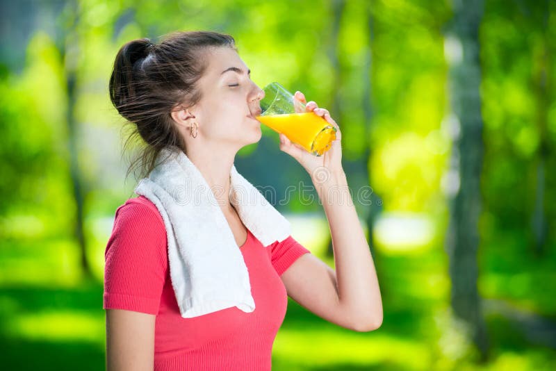 Woman drinking fresh orange juice royalty free stock photo Woman drinking fresh orange juice royalty free stock photo