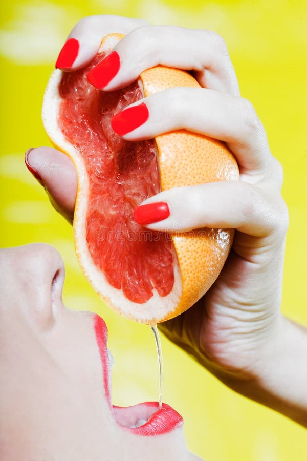 Woman drinking grapefruit juice