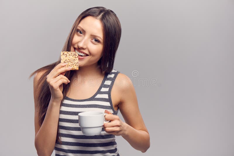 Woman drinking hot drink from disposable paper cup