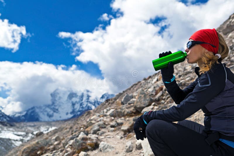 Woman drinking in mountains