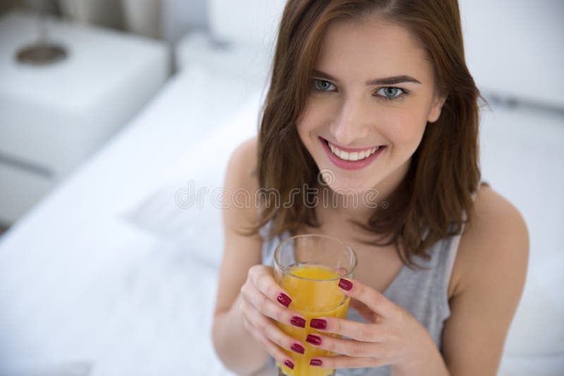 Woman Drinking Orange Juice on the Bed Stock Photo Image of beauty