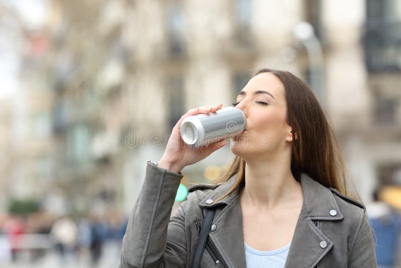 Woman drinking a refreshment from can