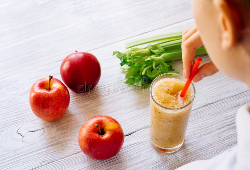 Woman Drinking a Smoothie of Apples and Celery in the Morning, V Stock