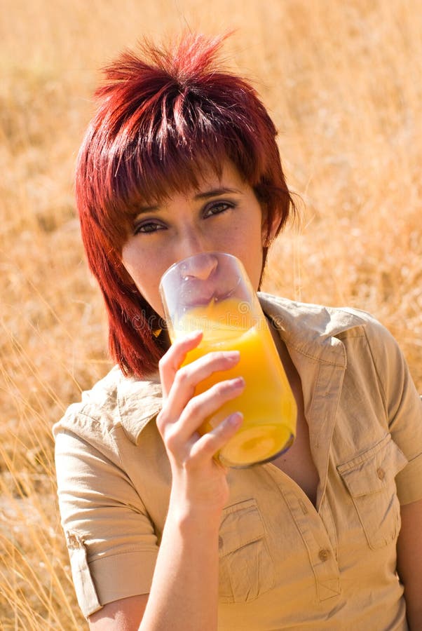 Woman drinks glass of juice