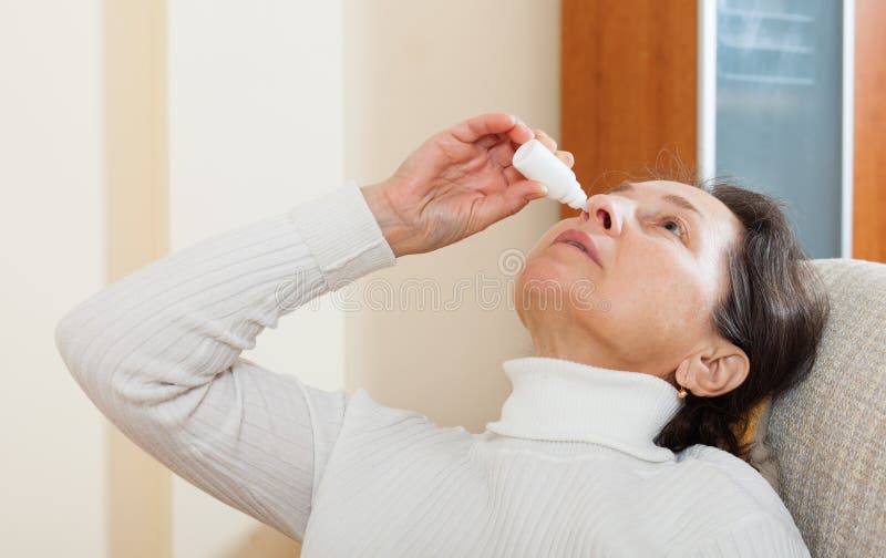 Woman dripping nasal drops