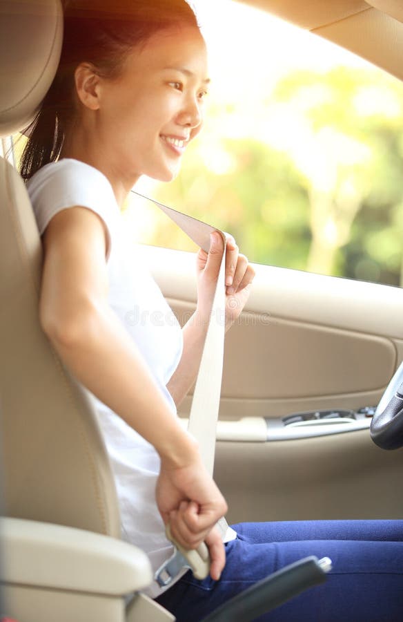Woman driver buckle up the seat belt in car royalty free stock photo Woman driver buckle up the seat belt in car royalty free stock photo