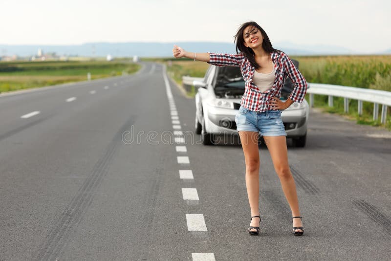 Woman driver hitch-hiking stock photo Woman driver hitch-hiking stock photo