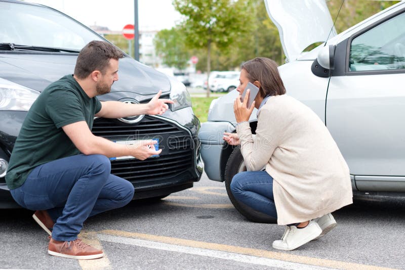 Woman Driver and Man Arguing about the Damage of the Car Stock Photo