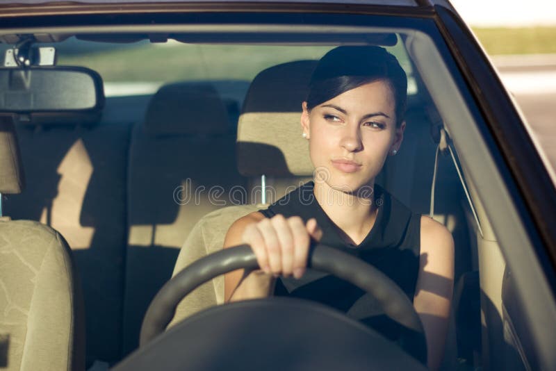 Woman driving her car in the evening