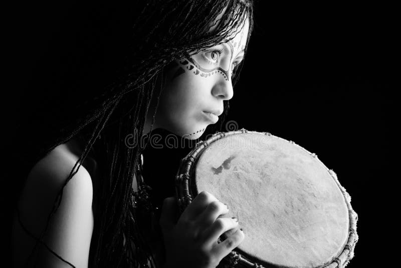 Beautiful ethnic young woman playing a drum. Beautiful ethnic young woman playing a drum.