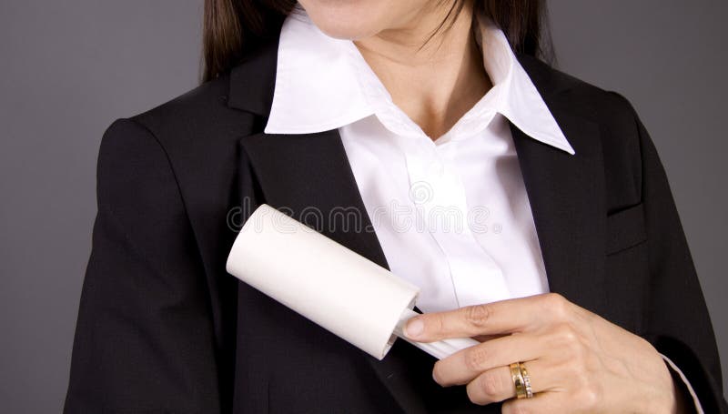 Woman dusting off suit