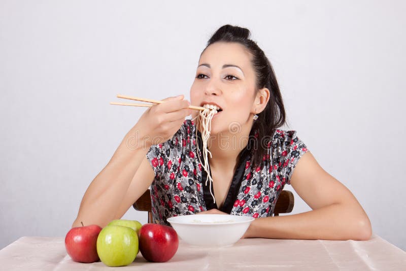 Asian business woman eating noodle