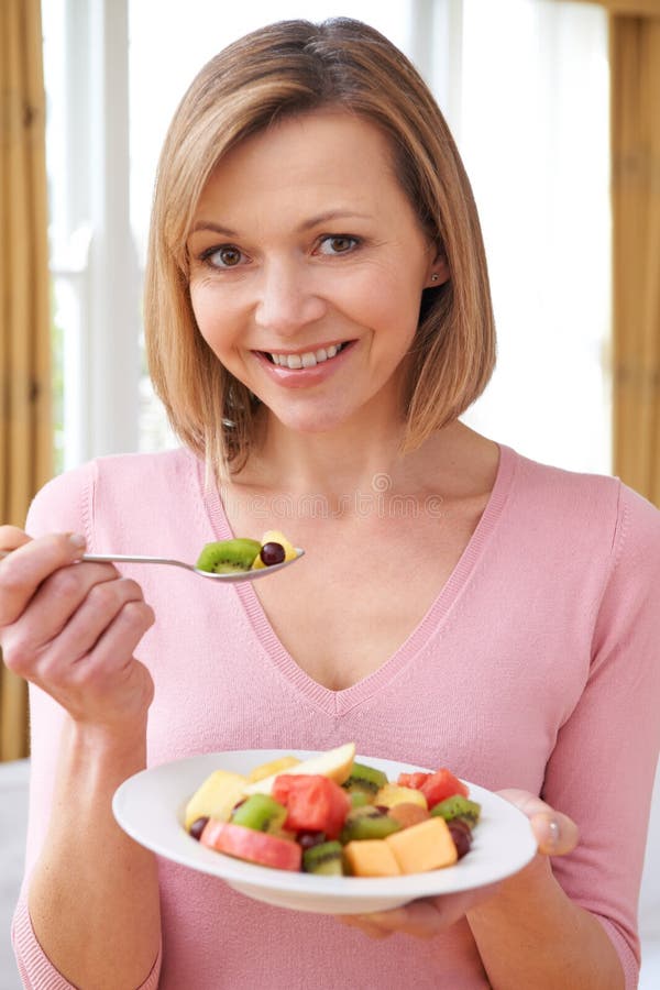 Woman Eating Bowl of Fresh Fruit Stock Photo Image of smiling, eating