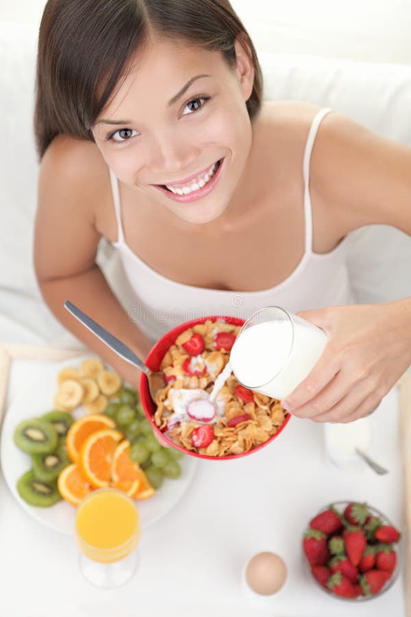 Woman eating breakfast in bed stock photography Woman eating breakfast in bed stock photography