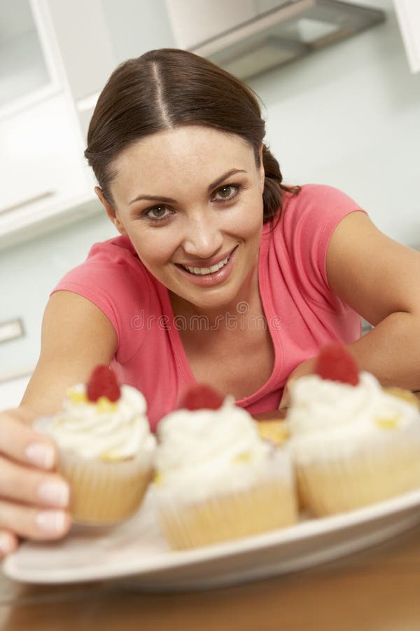 Woman Eating Cakes in Kitchen Stock Image Image of kitchen, food