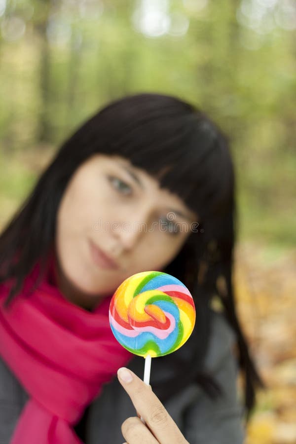 Woman eating candy lollipops